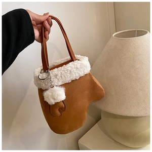 Detail of creative glove-shaped plush handbag in brown suede with white faux fur trim