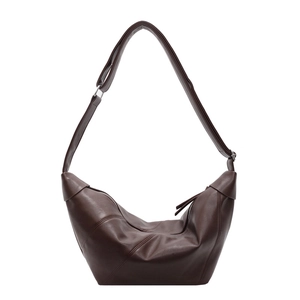 Minimalist deep brown croissant shoulder bag with adjustable strap on white background