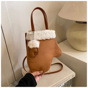 Detail showing glove-shaped crossbody bag with faux suede texture and faux fur trim