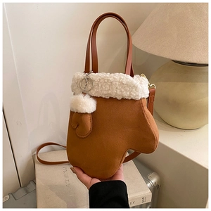 Detail of creative glove-shaped crossbody bag in brown suede with plush white faux fur trim