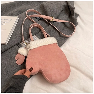 Close-up of pink suede mitten-shaped bag with white faux fur trim and gold hardware