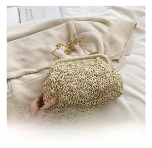 Detailed close-up of handmade beige woven cloud bag with elegant gold metal chain strap