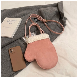 Detailed close-up of a pink glove-shaped crossbody bag with white faux fur trim and suede texture