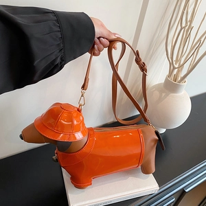 Creative orange dachshund puppy crossbody bag in glossy faux leather with a stylish cloak