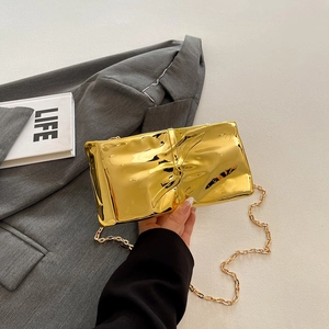 Elegant gold quilted crossbody bag with metallic wrinkled texture and chain strap
