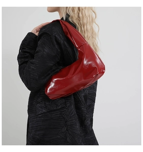 Glossy burgundy leather hobo bag with smooth finish and seamless shoulder strap