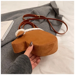 Creative brown mitten-shaped crossbody bag with white faux fur trim and suede finish