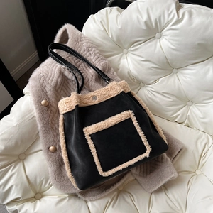 Fleece patchwork black tote bag for women shown on a winter coat and sofa background