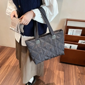 Deep grey quilted nylon tote bag featuring diamond embroidery and long shoulder straps