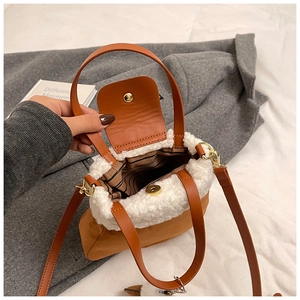 Detail view of the plush bucket bag interior with striped lining and magnetic closure