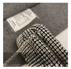 Detailed close-up of premium silver lobster clasp and metal chain on rhinestone bag