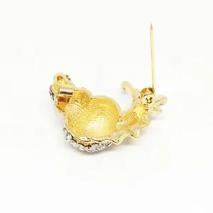 Enamel snail brooch with gold plating and sparkling rhinestones on white background