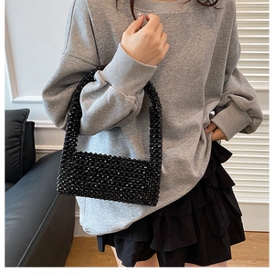 Fashionable black beaded handbag for women featuring a shimmering woven texture detail