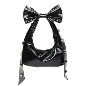 Glossy black crescent shoulder bag with a large bow and silver rivet details on white background