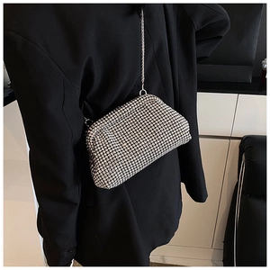 Macro shot of silver rhinestone evening bag with elegant metal chain and luxury details