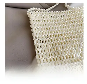 Detail of handcrafted cream pearl beads showing the intricate woven mesh and texture