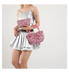 Detail view of pink pixel weave tote bag with thick handles and matching mini pouch