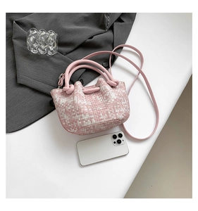 Detail of pink woven tweed handbag showing interior capacity with a smartphone reference