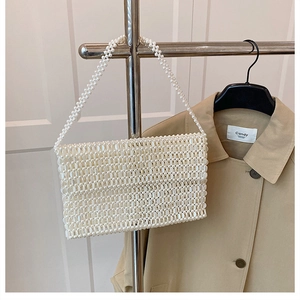 Close-up of handmade white pearl beaded bag with rectangular flat body design