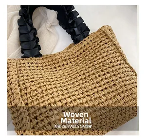 Detailed macro view of woven straw fabric texture and ruffled black satin handles