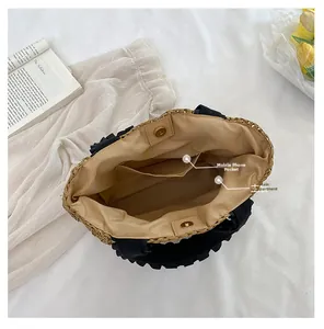 Interior view of straw tote bag showing spacious main compartment and phone pocket