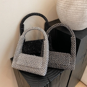 Elegant beaded evening handbags in black, silver, and gunmetal finishes on display