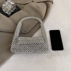 Silver beaded woven handbag with top handle and shimmering metallic beads for evening gala