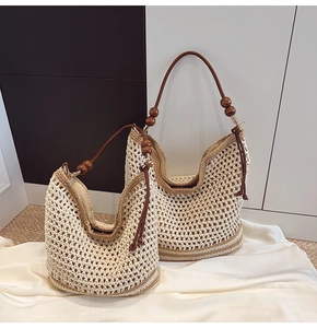 Detail of woven tote bag with wooden bead straps and cream-khaki crochet texture