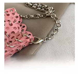 Detailed close-up of pink sequin handmade woven bag with premium silver metal chain hook