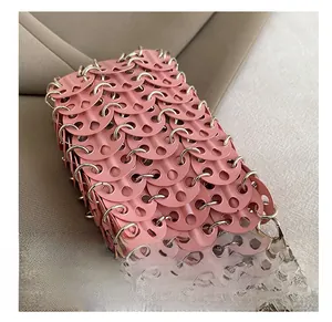 Detailed macro view of pink disc chainmail texture and silver metal ring assembly