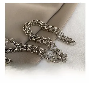 Macro shot of polished silver metal chain strap detail for women mini crossbody bag