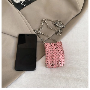 Pink mini crossbody bag size comparison with smartphone and elegant silver chain