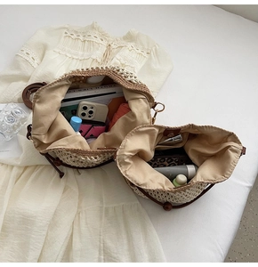 Top view of hollow straw tote bag showing spacious interior with leather handles
