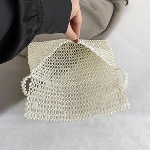 Handmade white pearl woven handbag with elegant beaded strap for summer fashion