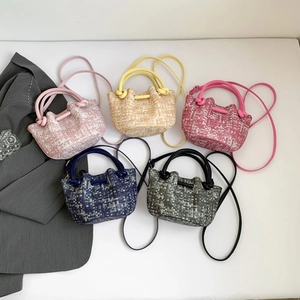 Five assorted colors of woven basket handbags with crossbody straps on white background