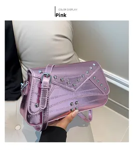 Detailed close-up of pink metallic leather bag with silver rivets and V-shape flap