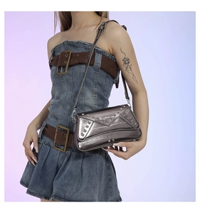 Chic silver Y2K shoulder bag with star rivets shown on a denim dress model outfit