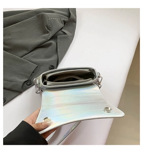 Detail view of the silver laser bag interior structure with magnetic buckles and pockets