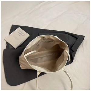 Interior view of soft cream leather tote bag featuring a spacious compartment and magnetic closure