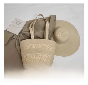 Detail of minimalist beige woven tote bag paired with a matching wide-brim straw sun hat