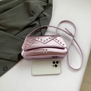 Pink metallic crossbody bag with star rivets and glossy finish on white background