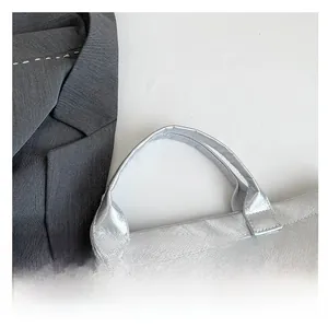 Detailed view of silver metallic DuPont paper tote bag with reinforced stitched handles