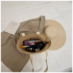 Interior view of a spacious straw tote bag showing large capacity for travel essentials