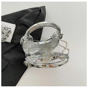 Detailed top view of a silver mirror acrylic evening bag with transparent stitching
