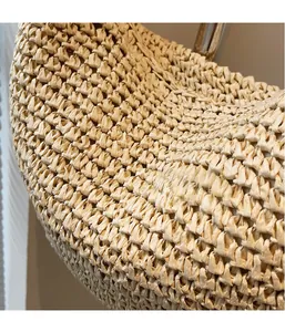 Detailed close-up showing the dense woven texture of this beige straw summer beach bag