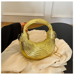 Detail of gold crescent evening bag with radial pleats and metallic chain handle