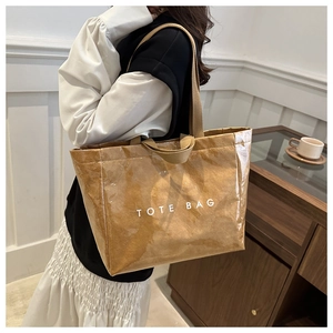 Detail of waterproof Dupont paper tote bag with white text print and brown texture