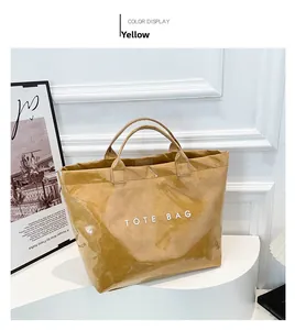 Close-up of yellow wrinkled texture tote bag on display stand with TOTE BAG text