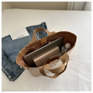 Top view of large capacity tote bag showing spacious interior with laptop and books