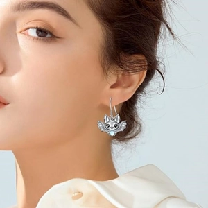 Gothic silver bat earrings with blue moonstone pendant worn on a model's ear